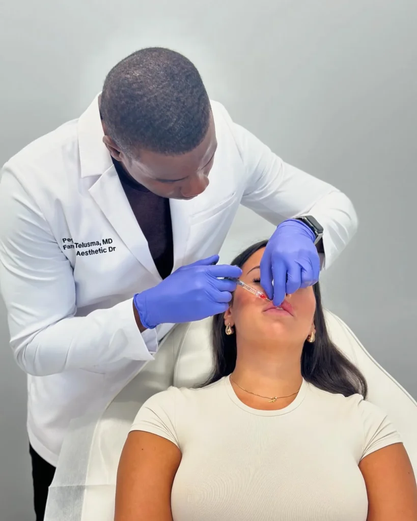Dr Peguy Télusma, MD, performing a lip filler injection at GLIF Medical, Montreal